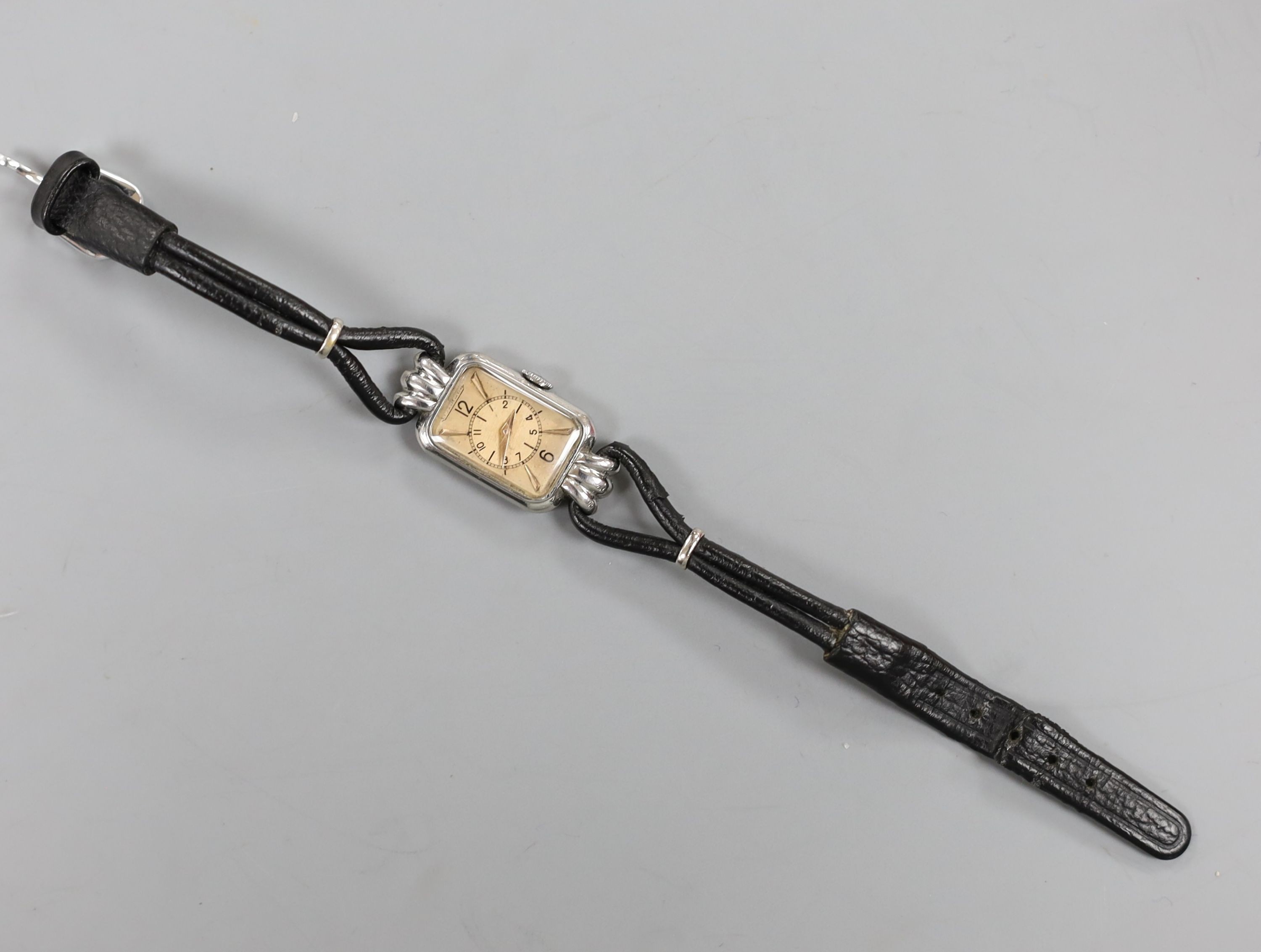 A lady's Art Deco steel Jaeger Le Coultre manual wind wrist watch, on fabric strap.